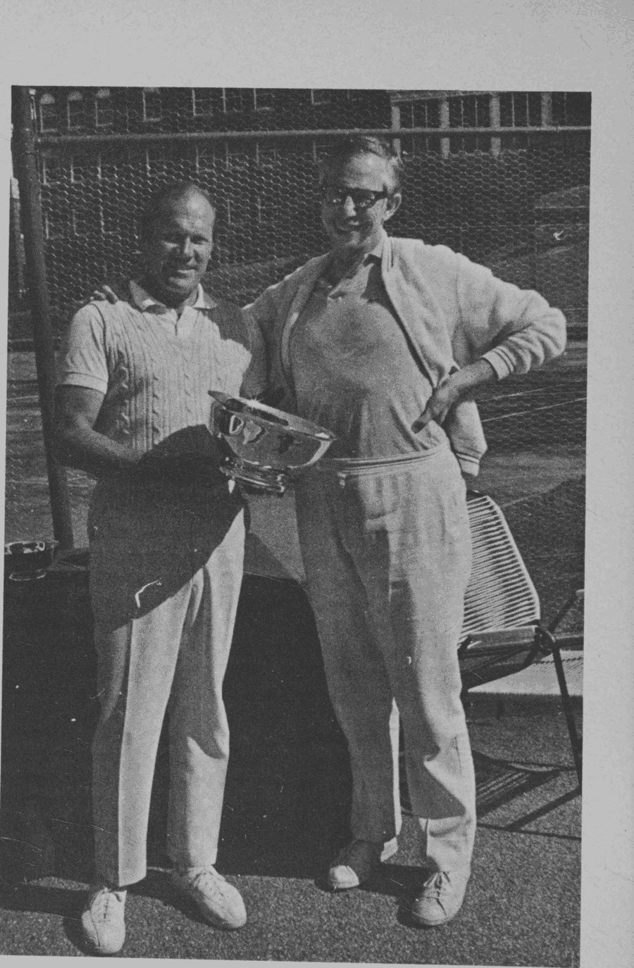Dr. Claude Frazier receiving a cup from Hal Burrows at a Spring 1974 tournament. Burrows, a former member of the Davis C